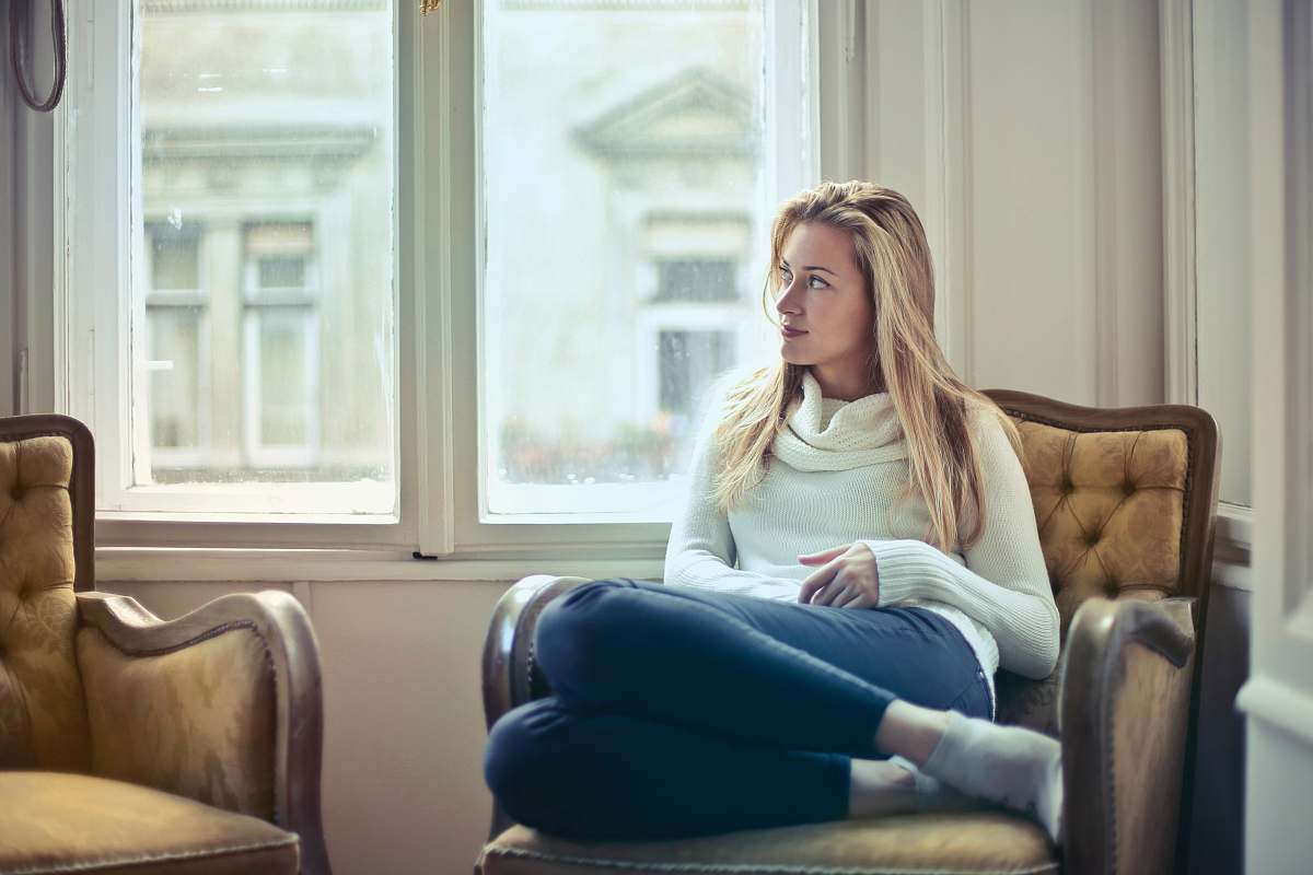 human woman sitting on brown armchair person