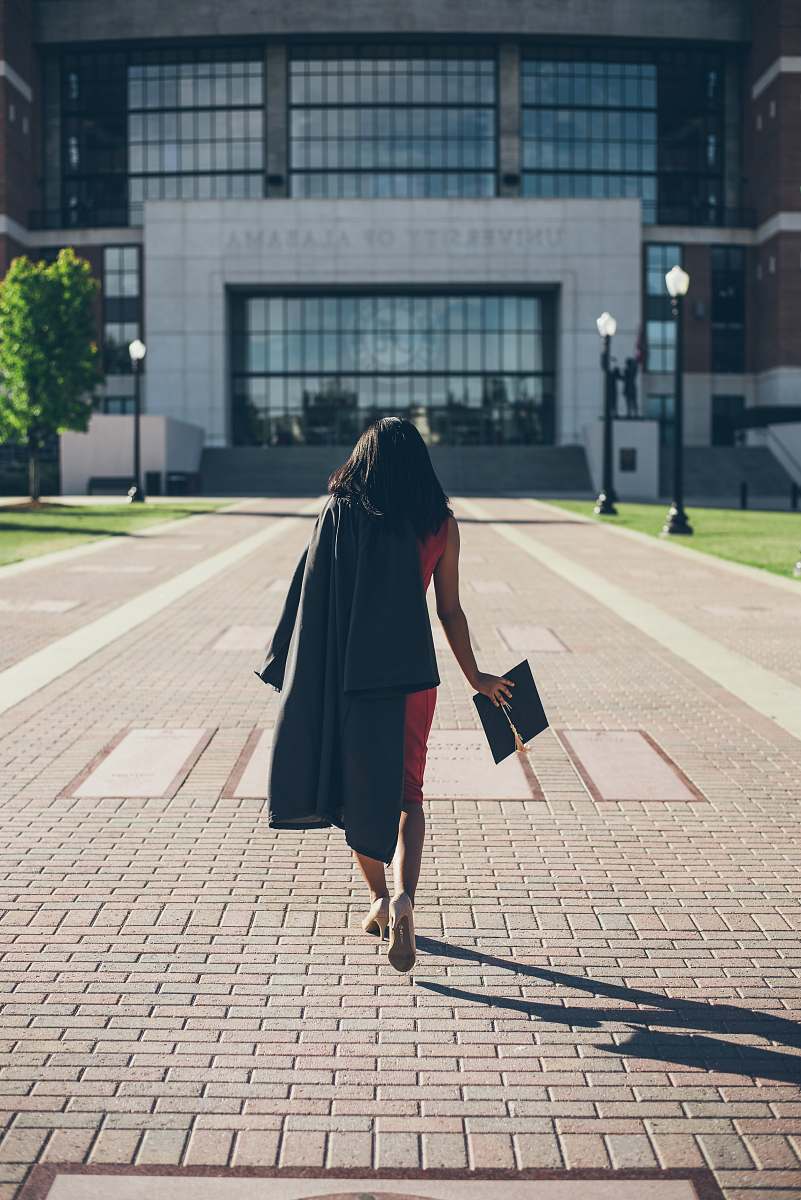 person woman standing at facade of Alabama University building human