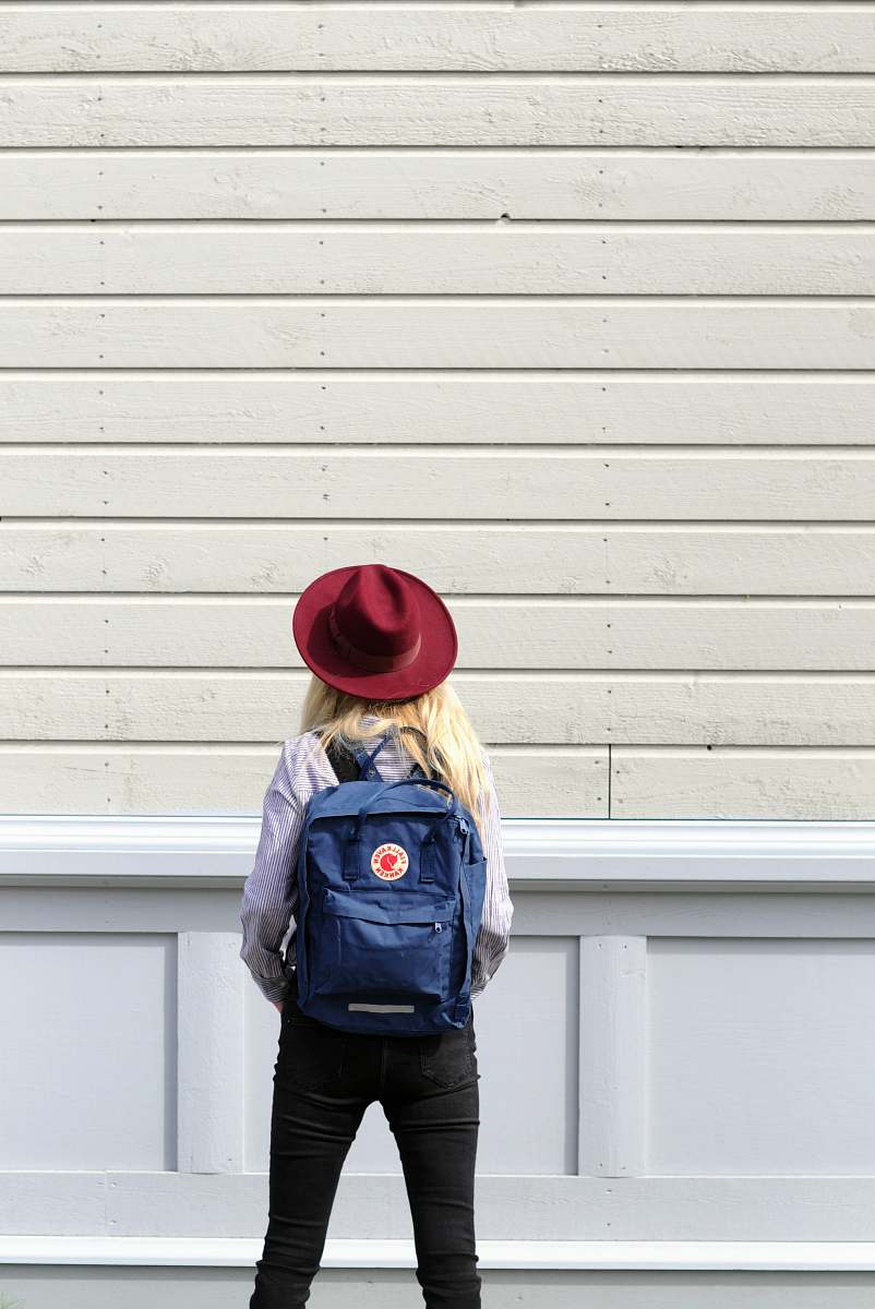 person woman standing in front of wooden wall human