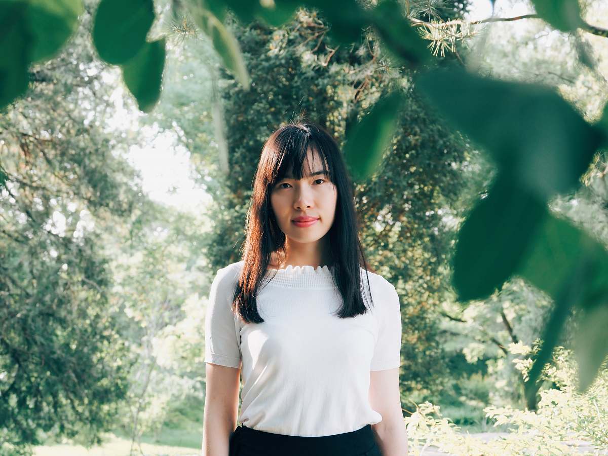 person woman standing in middle of forest showing smile woman