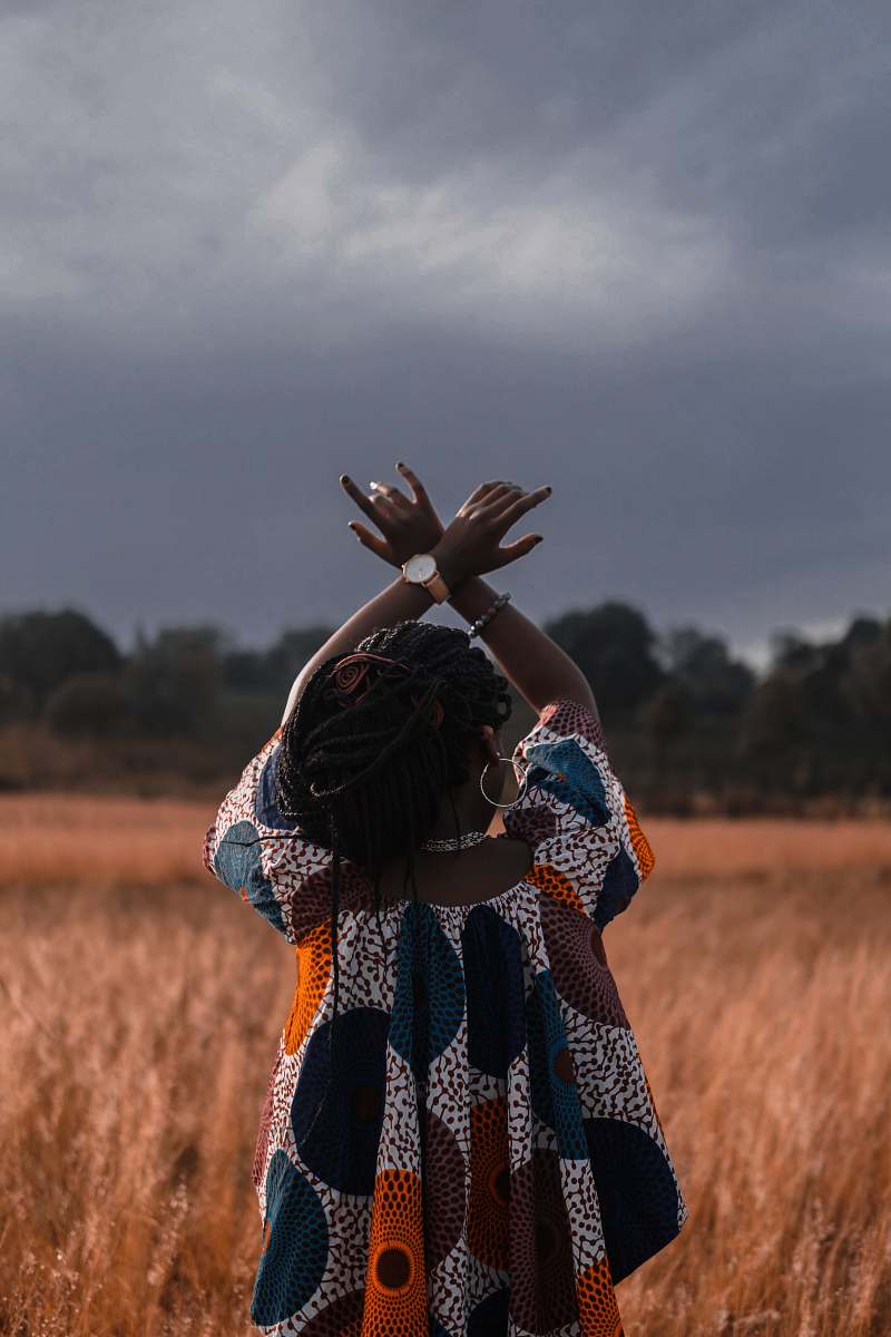 person woman standing in the middle of wheat field woman