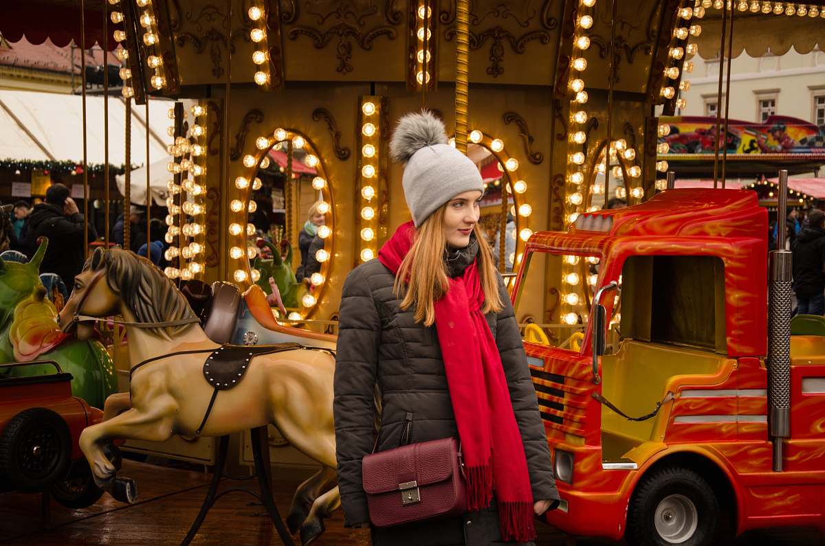 person woman standing near lighted carousel human
