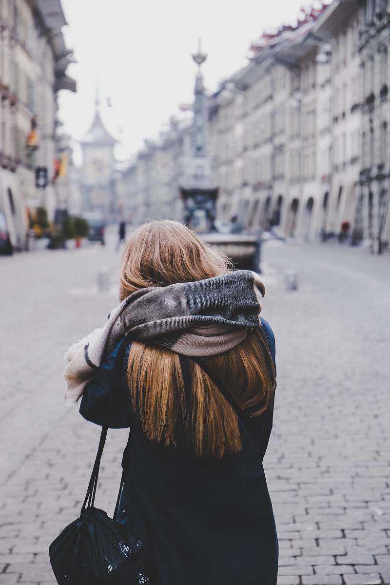 person woman standing on sidewalk during daytime human
