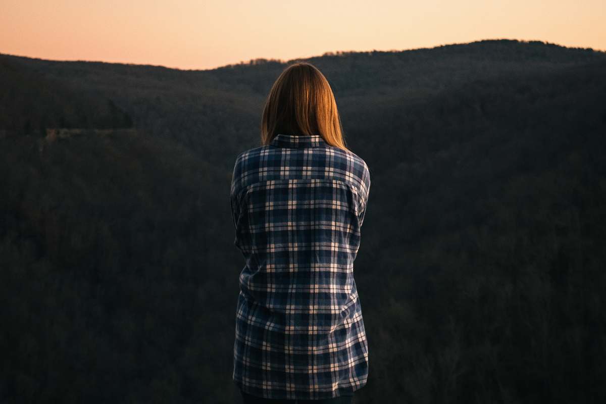 person woman standing while facing the mountain human
