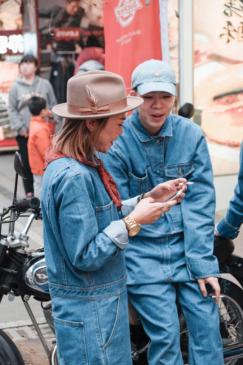 person woman using smartphone in street motorcycle