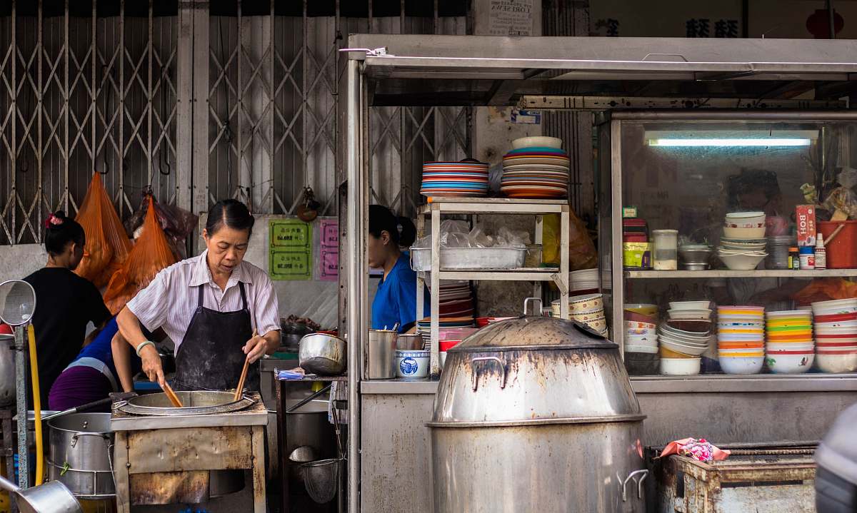 person woman wearing black apron while cooking human