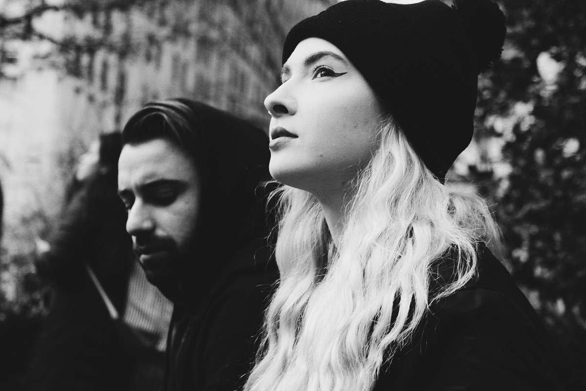 black-and-white woman wearing black knit cap near man human