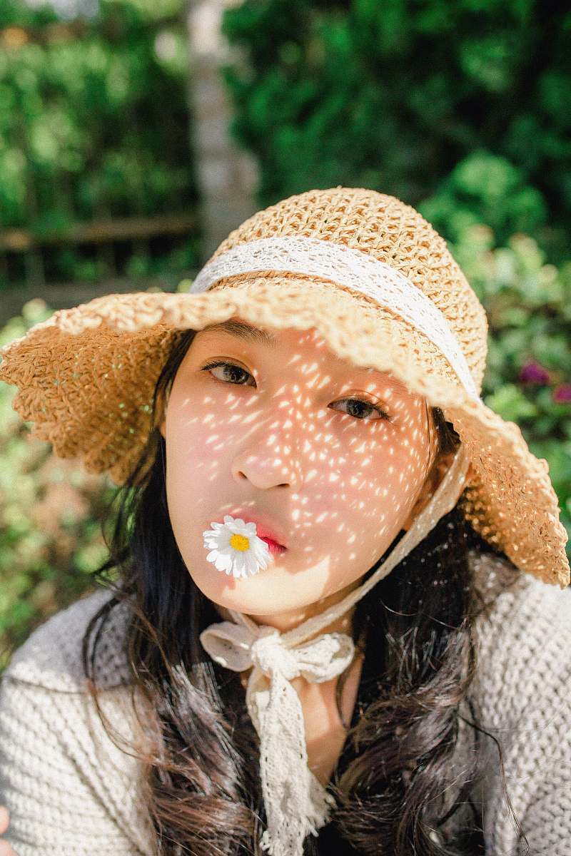 person woman wearing sun hat in flower garden human