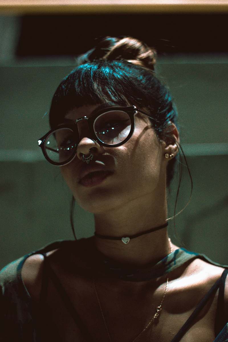 glasses woman with black spaghetti strap top hair