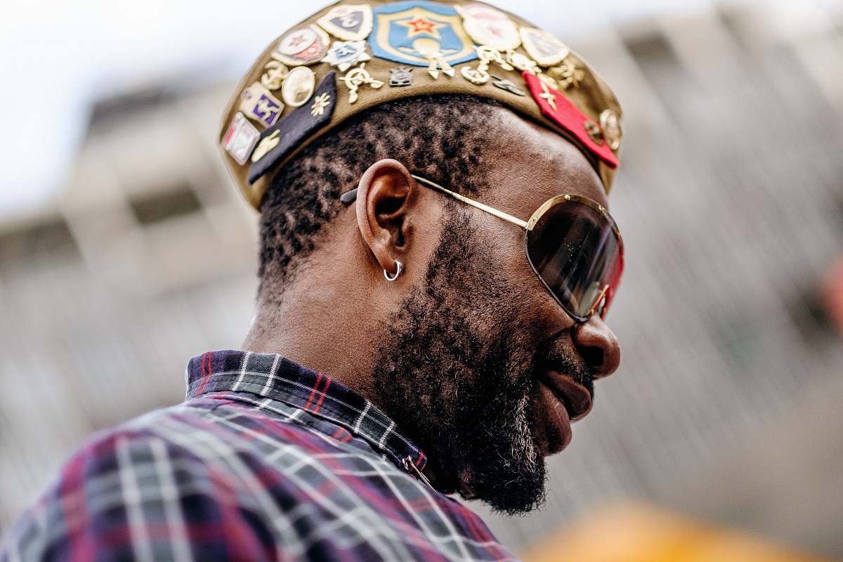 people close-up photography of smiling man wearing sunglasses human
