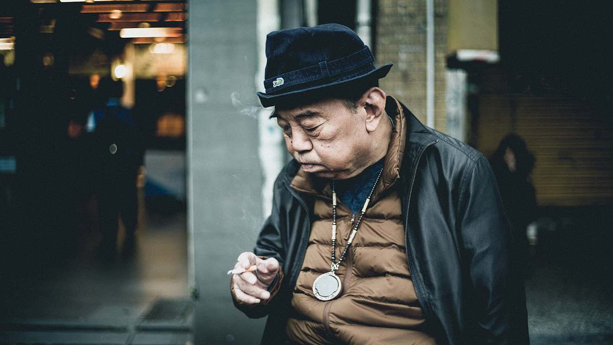 people man in black leather jacket using cigarette human