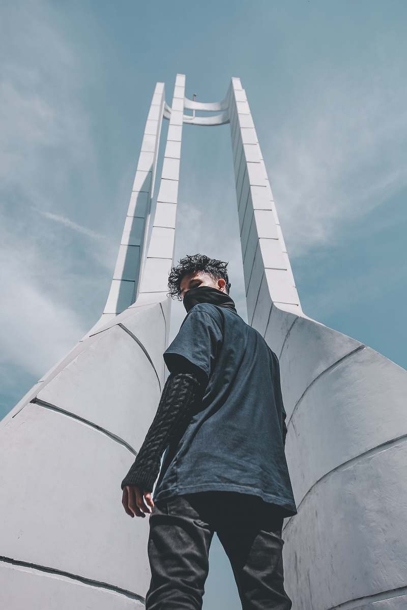 people man in black shirt standing at the front of tower grey