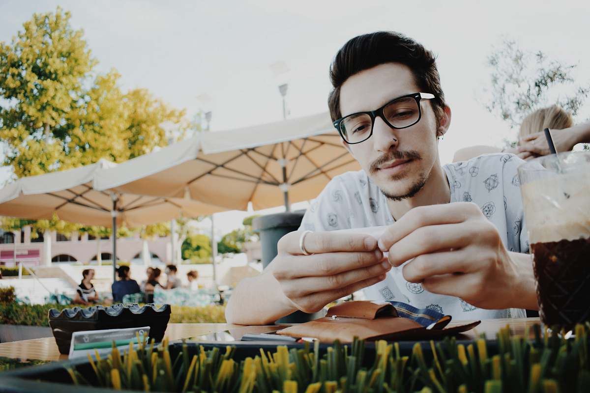 human man sitting beside table people