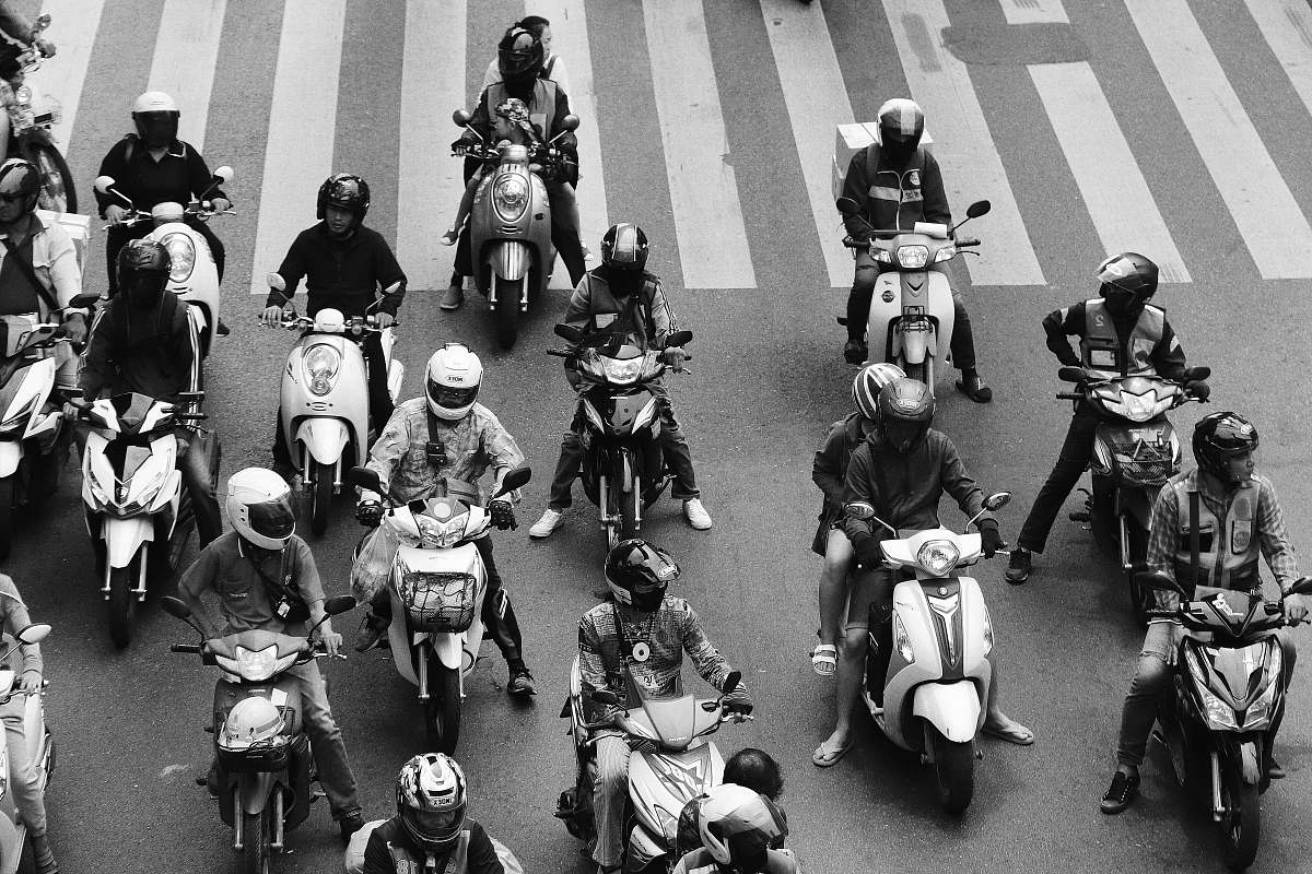 people people ride-on motorcycles at the road grayscale photography black-and-white