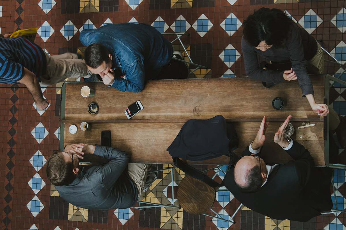 people people sitting near brown wooden coffee table human