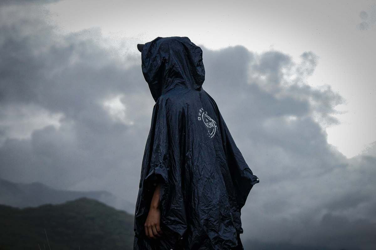 people person wearing black raincoat under the rain human