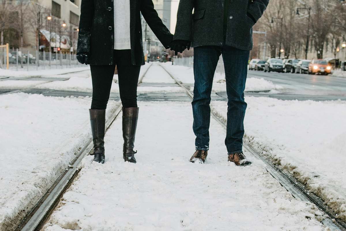 human photo of two person standing on snow-covered road people