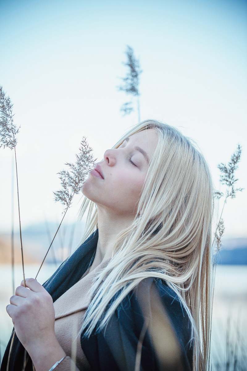 people selective focus photo of woman holding green plant during daytime human