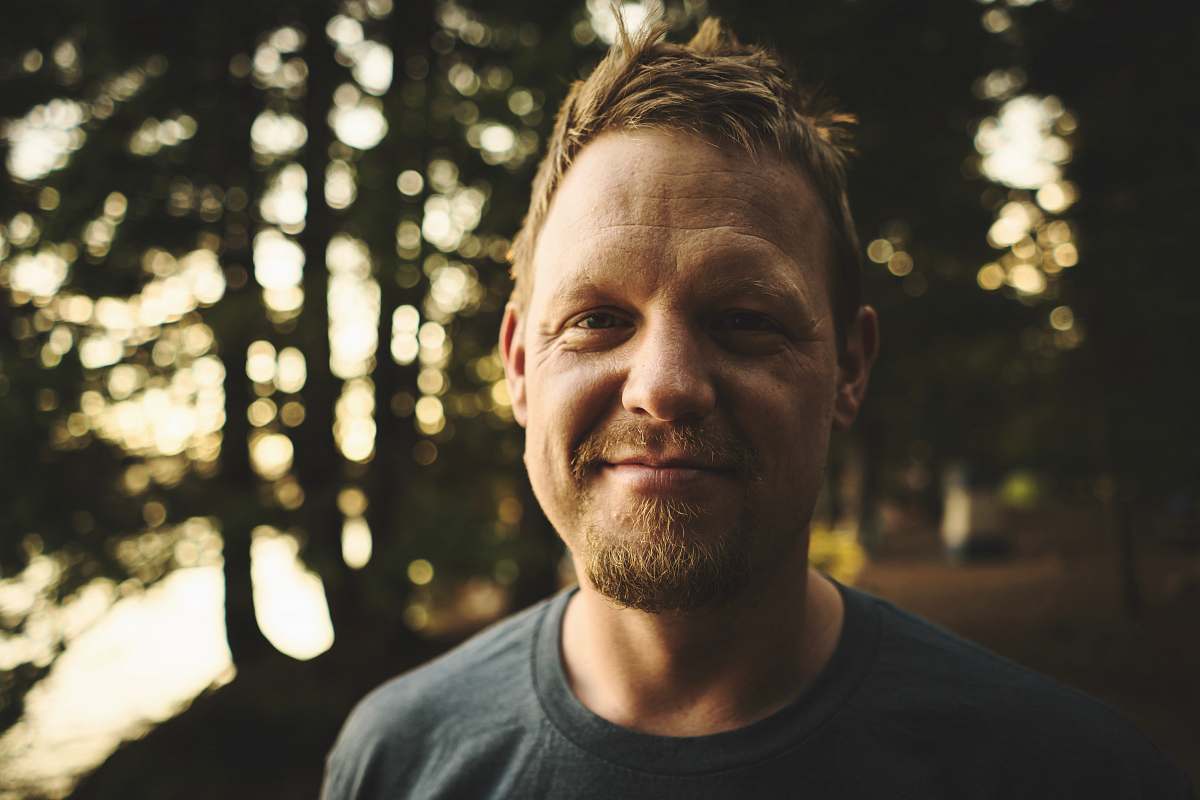 people selective-focus photography of man wearing crew-neck shirt human