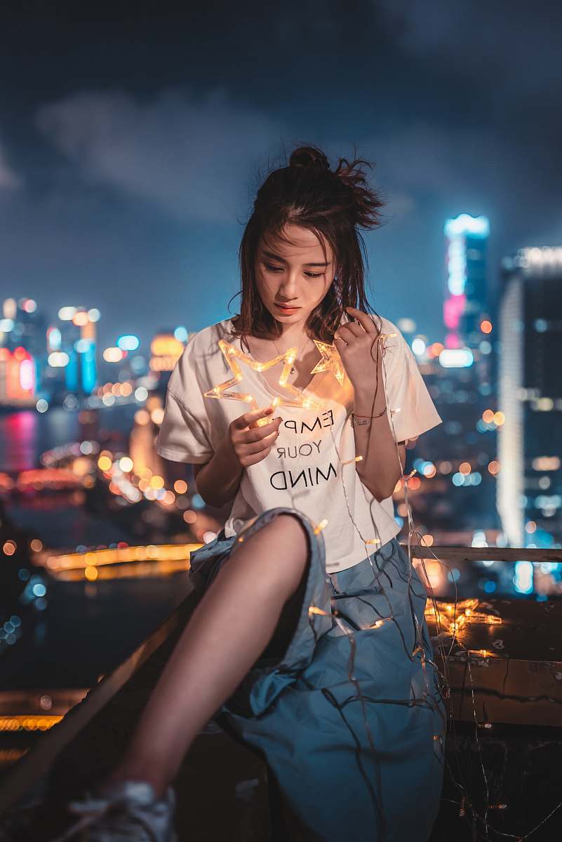 people woman holding star-themed string lights human