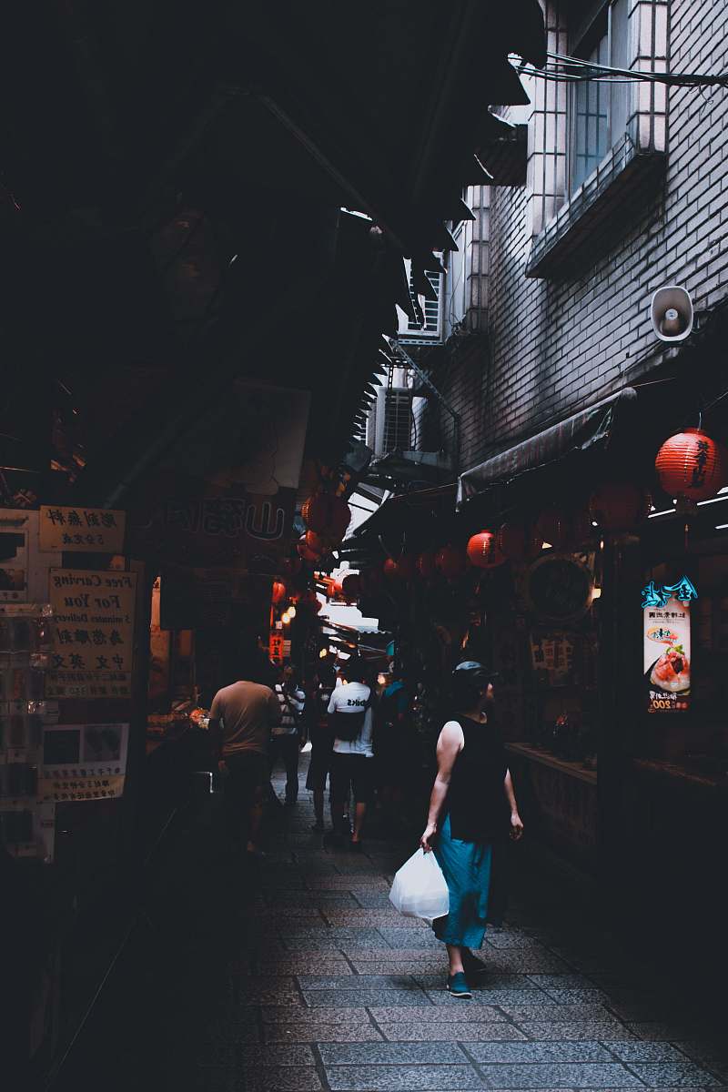 people woman in black sleeveless top carrying white plastic human