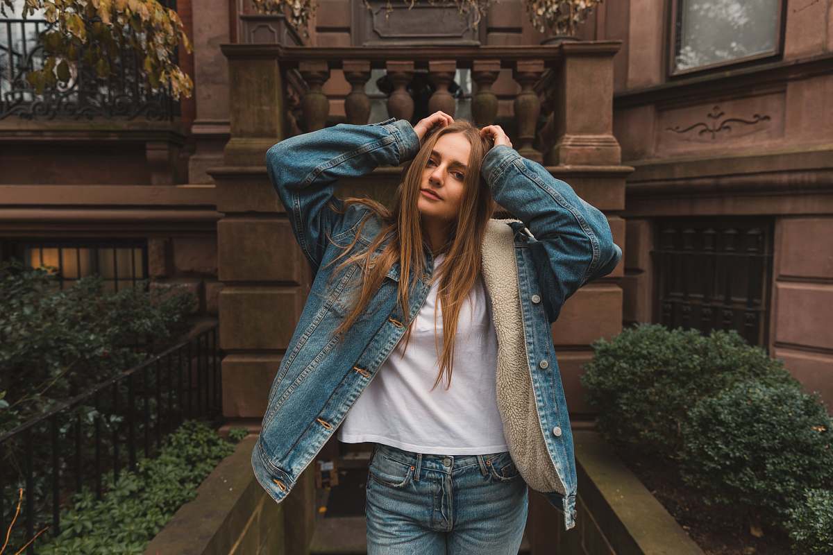 people woman in blue denim jacket standing in front of hour human