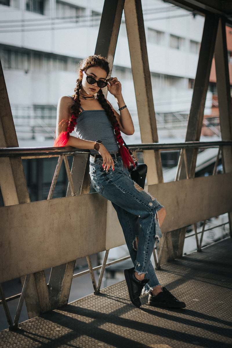 human woman leaning on brown metal frame at daytime people