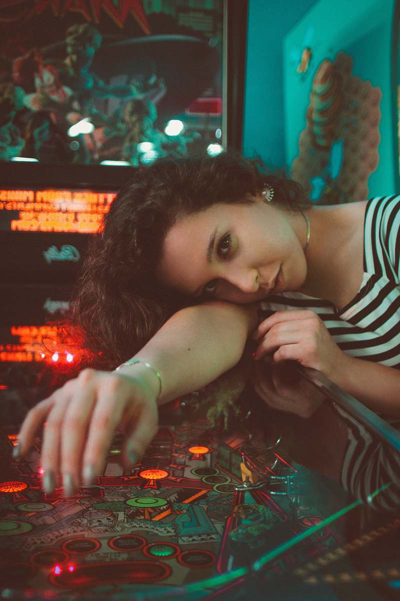 people woman leaning on pinball machine human