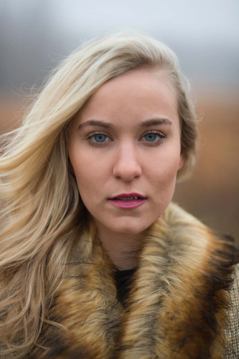 people woman looking at camera wearing brown fur scarf woman