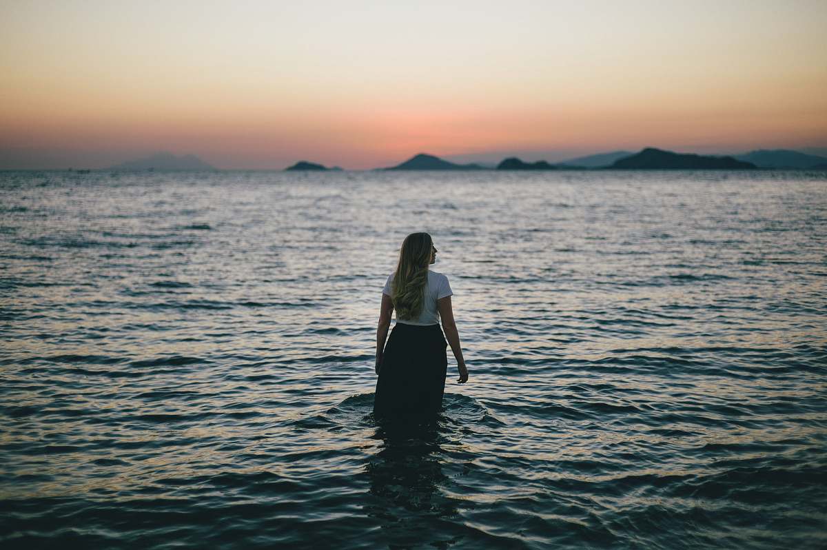 people woman walking on body of water human