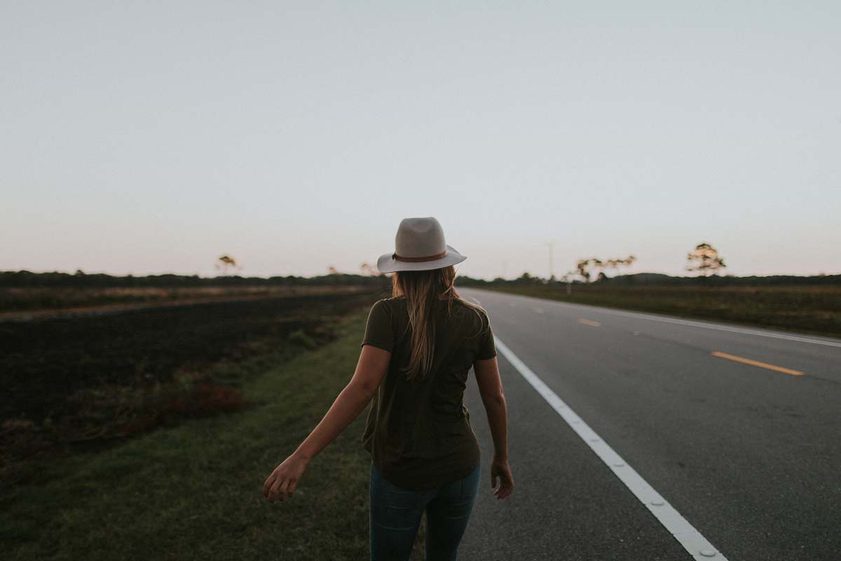 people woman walking on side of the road human