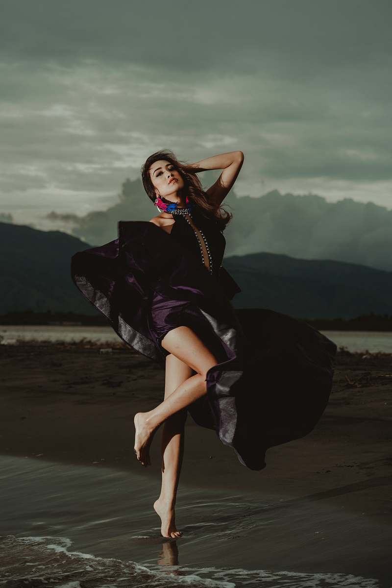 people woman wearing purple dress standing on shoreline human