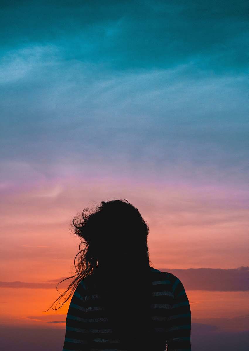 people woman wearing striped standing under cloudy sky human