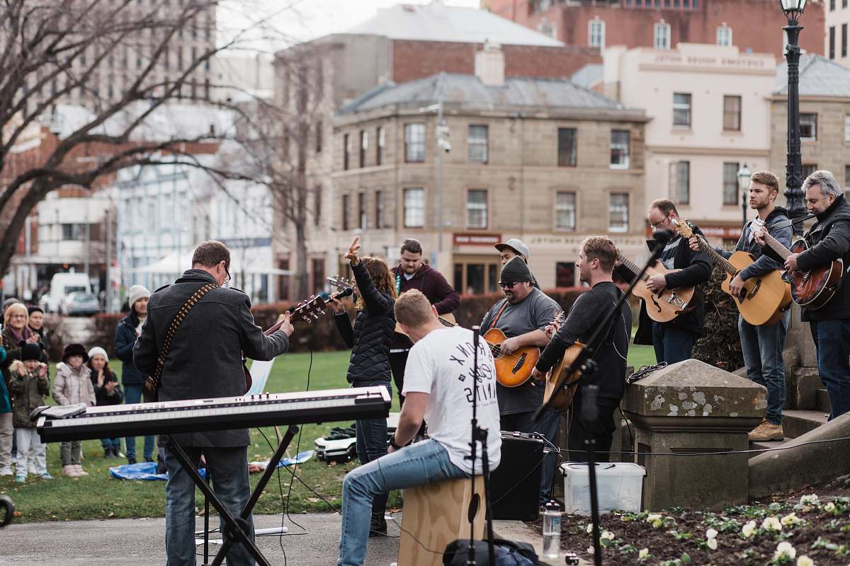 clothing man in blue long sleeve shirt playing electric guitar footwear
