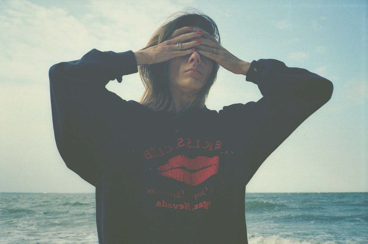 clothing woman covering eyes by sea sleeve