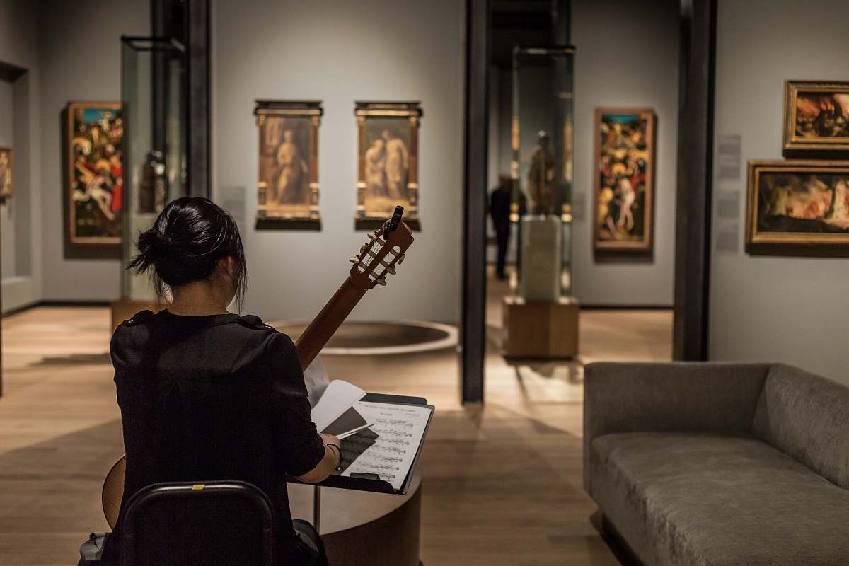 couch woman playing classical guitar furniture