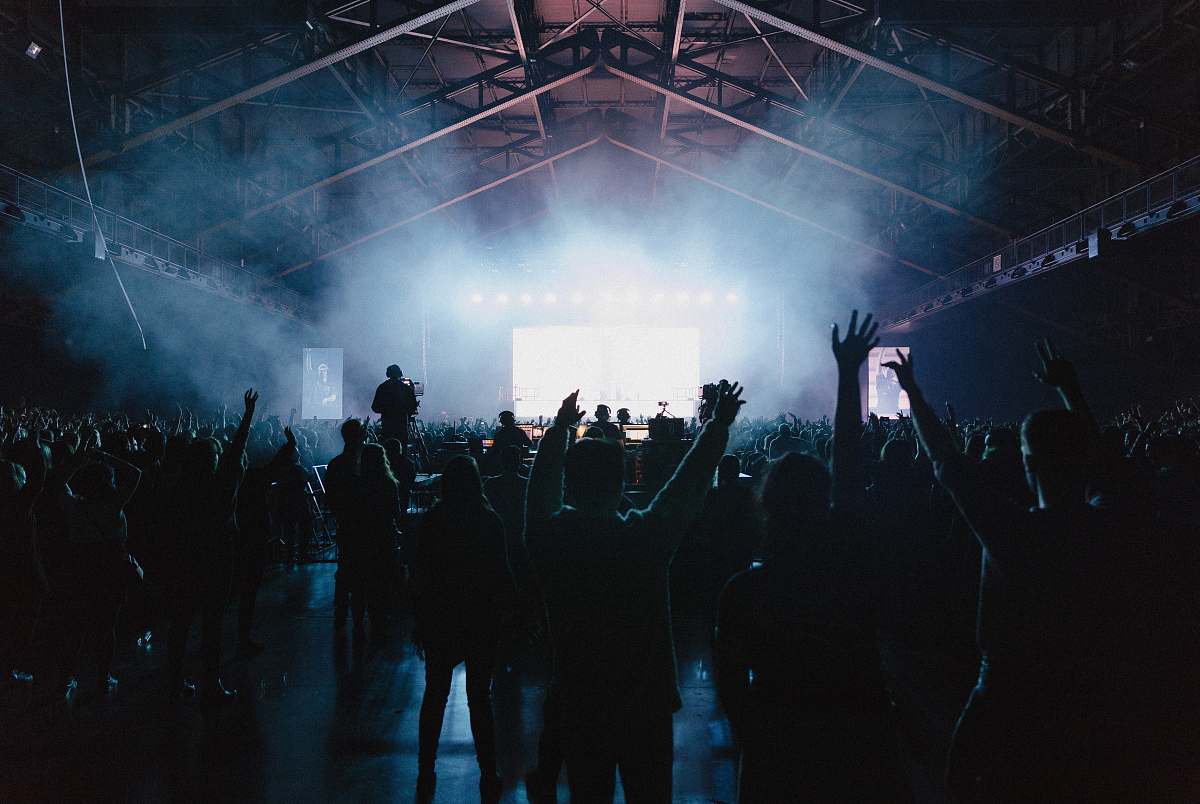 concert group of people raising hands music