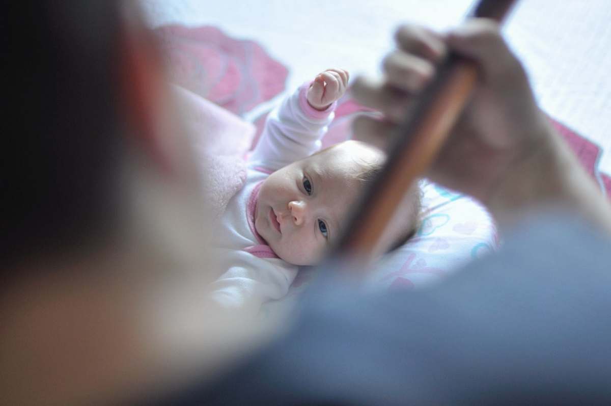 family toddler lying on bed with comforter r. euzébio de queirós