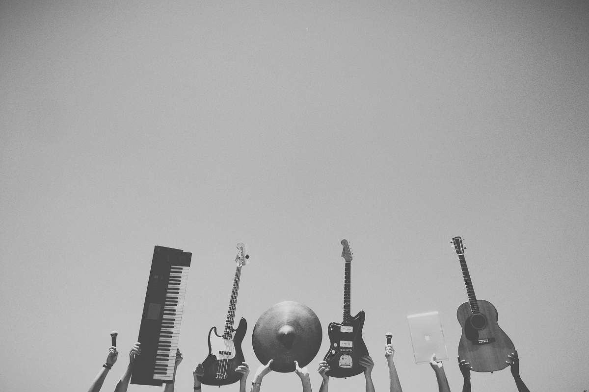 guitar grayscale photo of people holding assorted music instruments grey