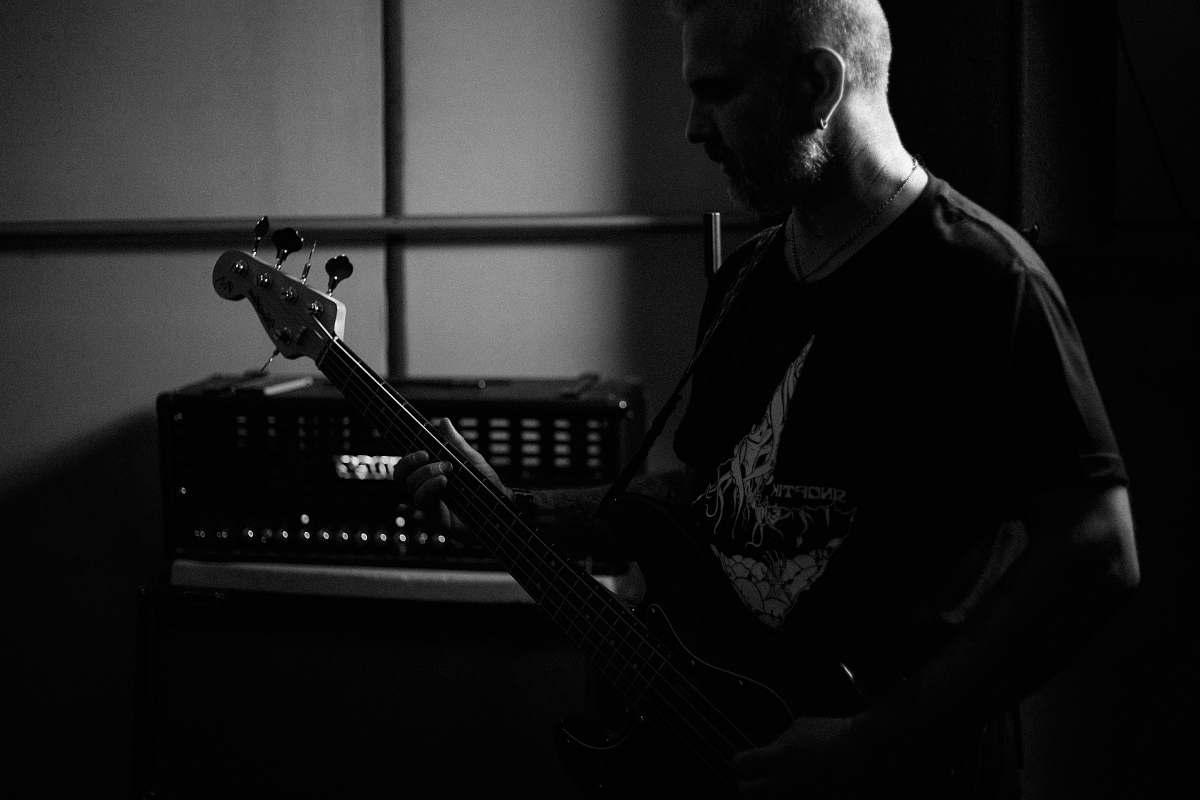 human gryascale photo of person playing electric guitar person
