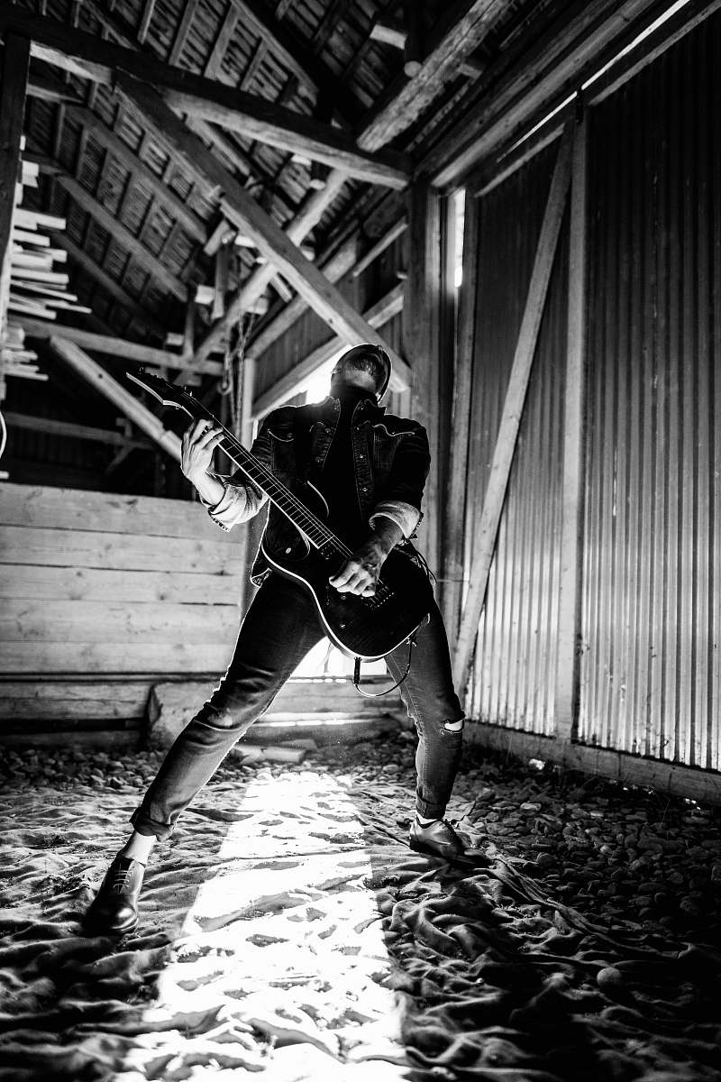 guitar man playing electric guitar beside wall music