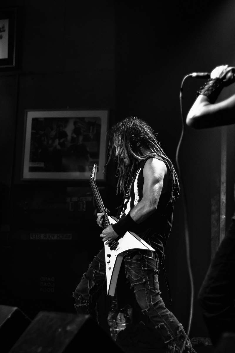 guitar man playing electric guitar inside black room musician