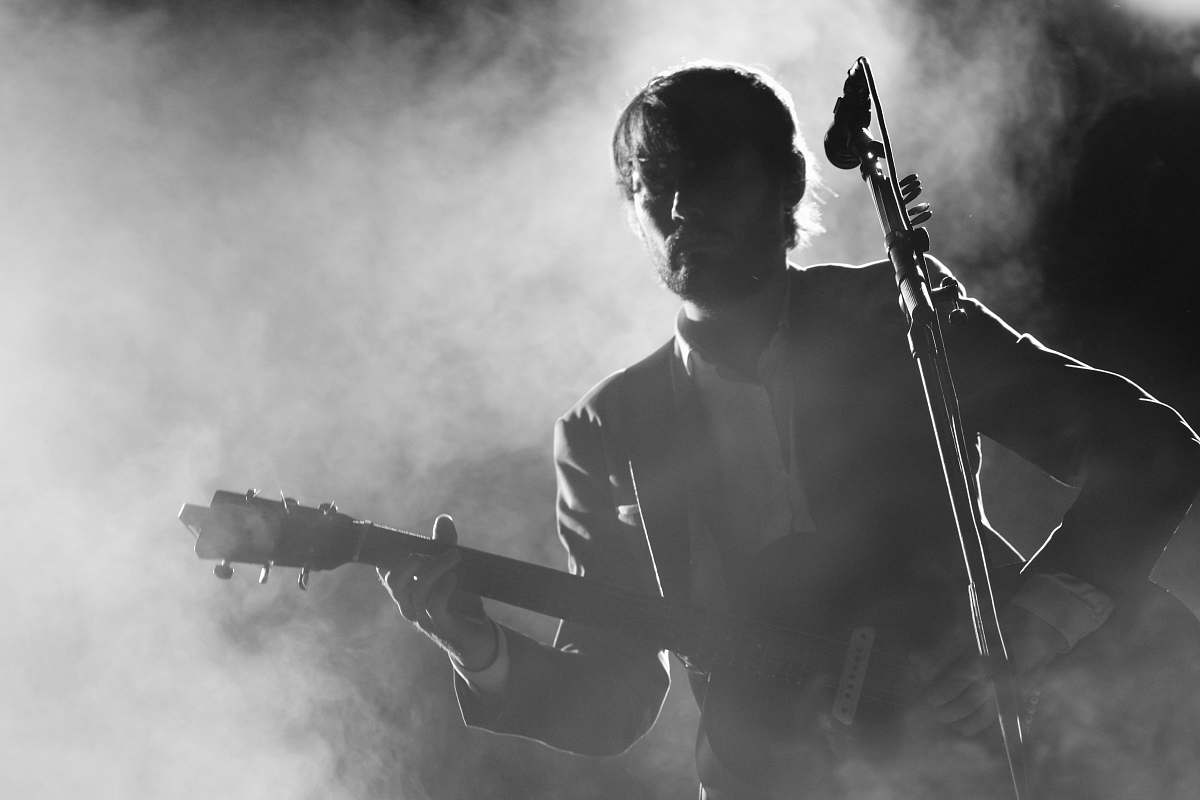 Human Silhouette Of Man Playing A Guitar Beside A Microphone People 