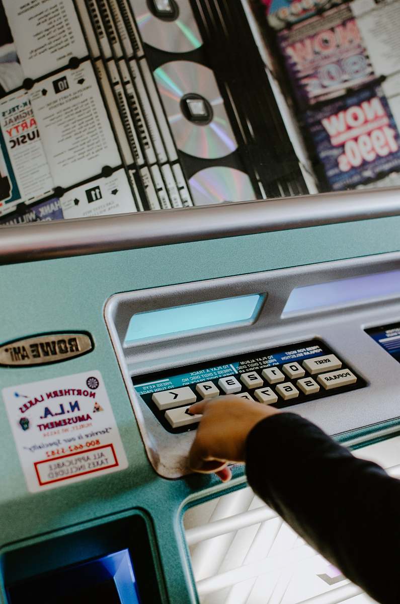 player person touching white button on machine album