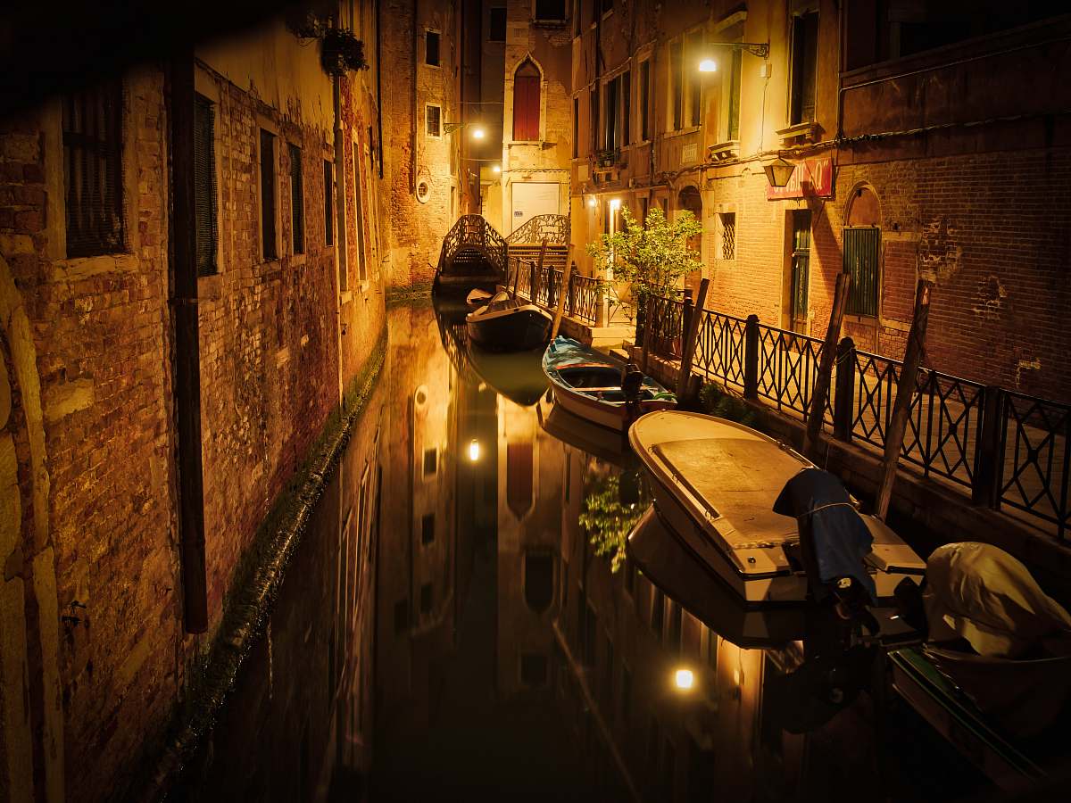 venice boats between buildings italy