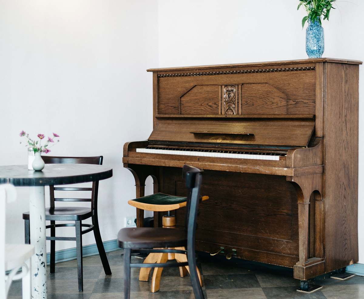 furniture brown piano in front of white wall table