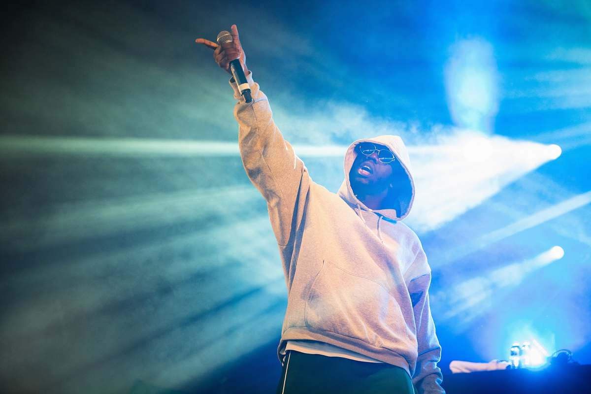 human man raising his left hand with microphone person