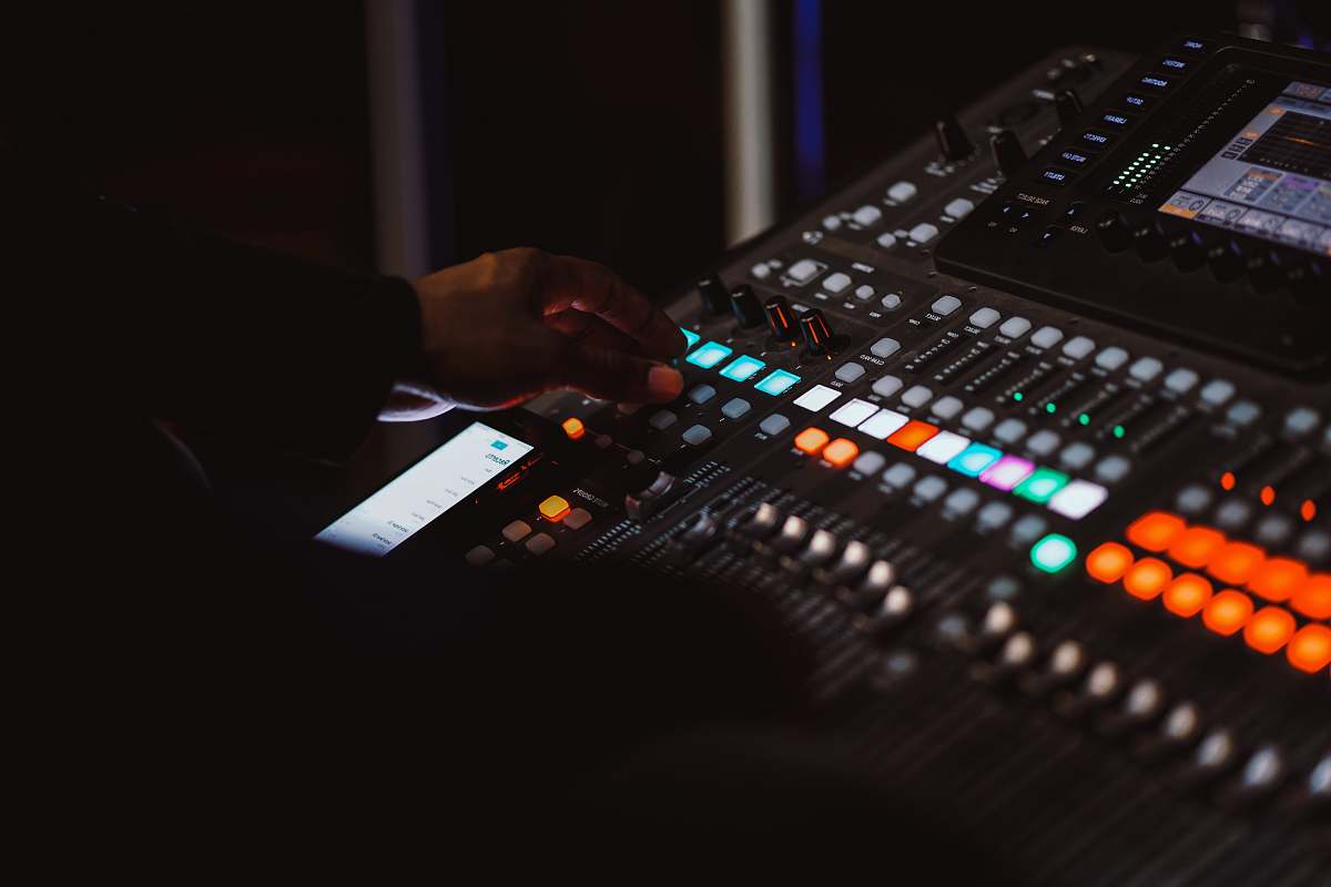 electronics person using audio mixer button
