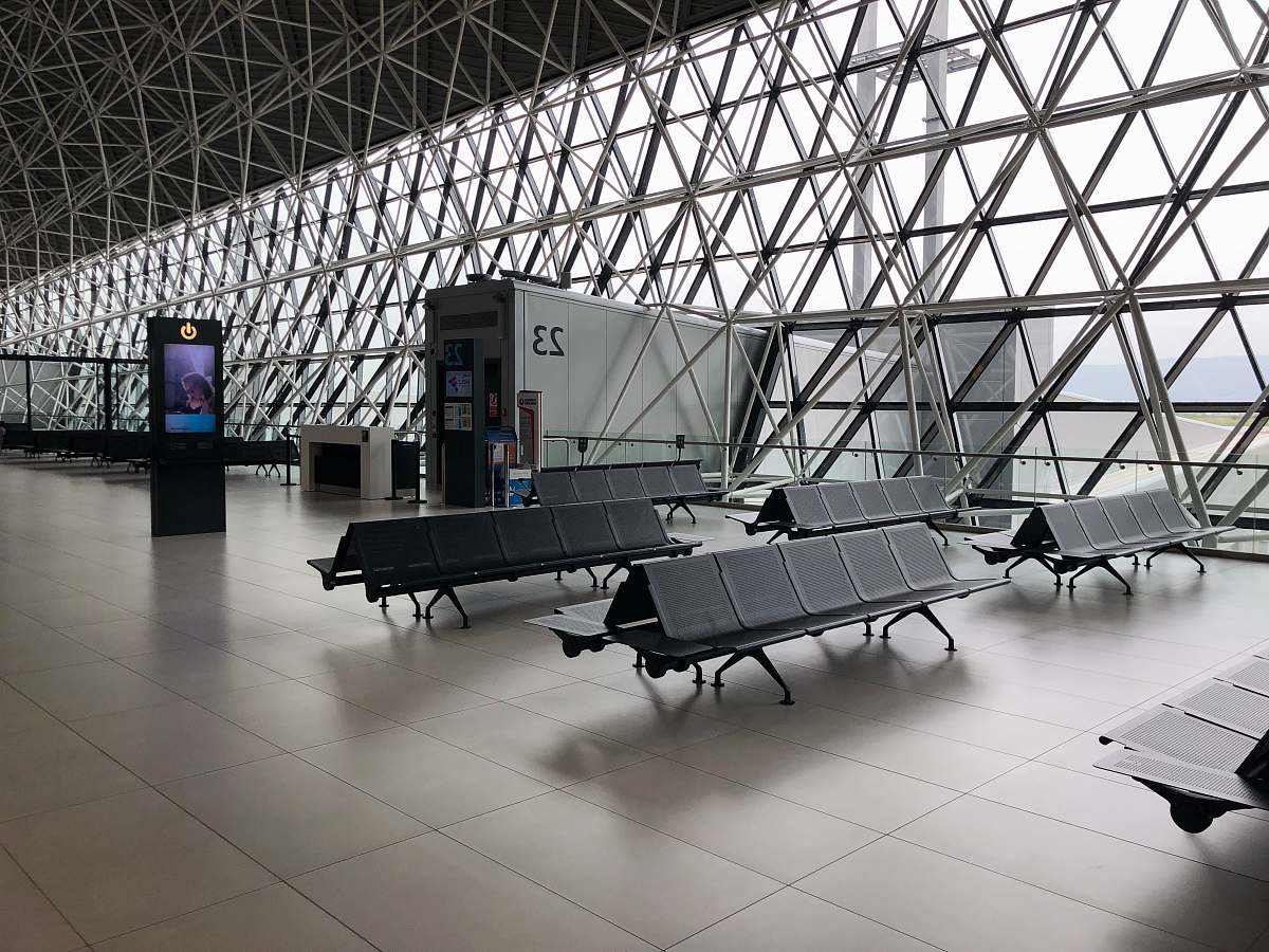 space black metal gang chairs on white ceramic flooring seatting