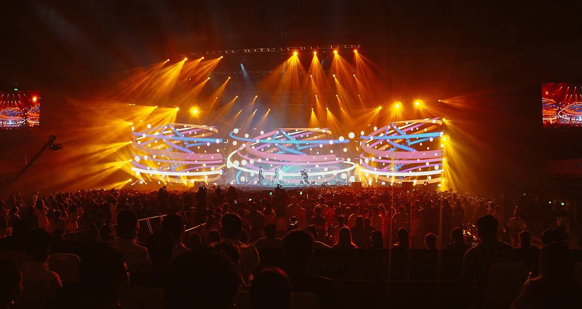 human crowd in front of lighted stage person
